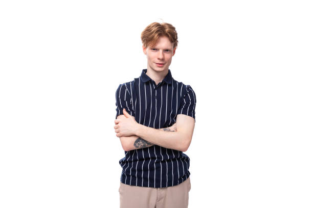 istock handsome 25s blond man dressed in a tank top with tattoos posing on a white background 1821242918