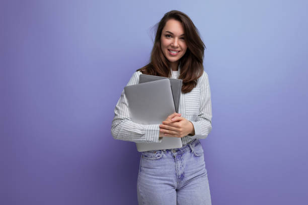 istock smart successful brunette young lady freelancing with hair below her shoulders with documents and a laptop 1821243472