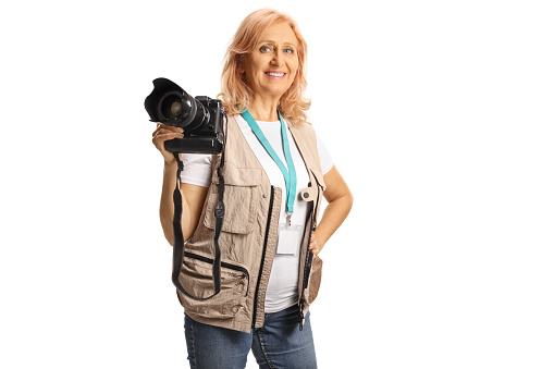 Female photo journalist with camera in her hand isolated on white background