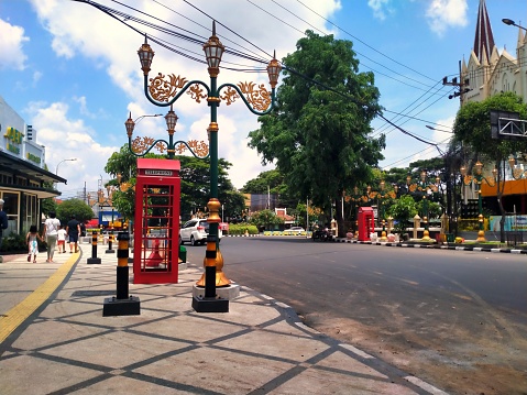 Malang, Indonesia - November 26, 2023 ; Pedestrians in The Kayutangan Heritage area in Malang City are getting a facelift by adding permanent benches, widening the sidewalks, and adding bollards.