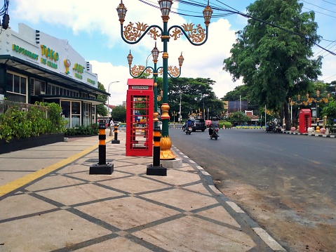 Malang, Indonesia - November 26, 2023 ; Pedestrians in The Kayutangan Heritage area in Malang City are getting a facelift by adding permanent benches, widening the sidewalks, and adding bollards
