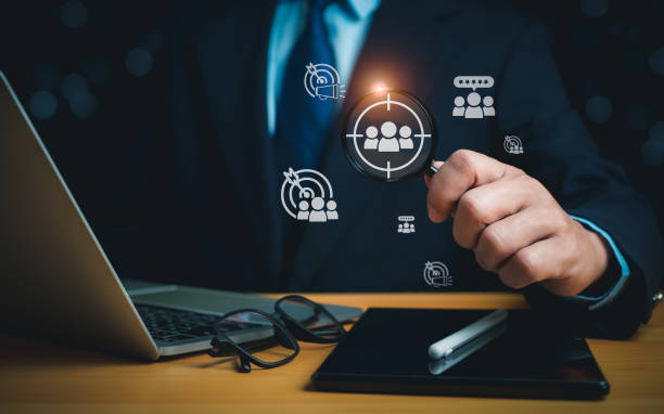 istock Businessman use a magnifying glass to find business target groups,Target customer, Customer behavior concept. Marketing plan and strategies. Personalization marketing, Customer centric strategies. 1821417256