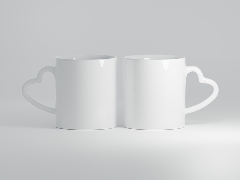 Realistic 11oz Heart Shaped Handle Ceramic Mugs Mock Up on a Plain White Background as 3D Rendering - Two Mugs.