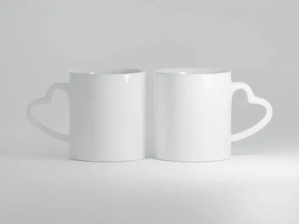 Photo of Two Heart Shaped Handle Ceramic Mugs Isolated on a Plain White Background