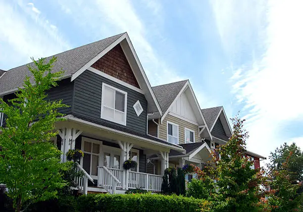 Partial view of new homes in a suburban neighbourhood on a sunny day.  See also