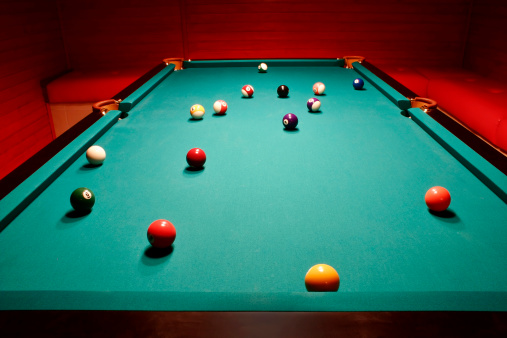 Pool table with balls at red interior.