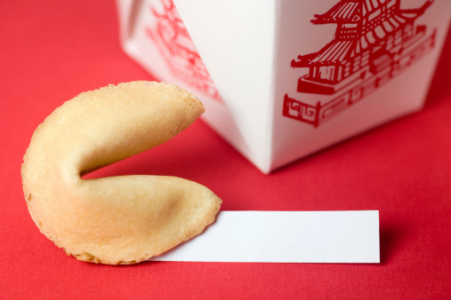 Fortune cookie and a Chinese takeout box.  The fortune cookie shows a blank slip of paper for text.