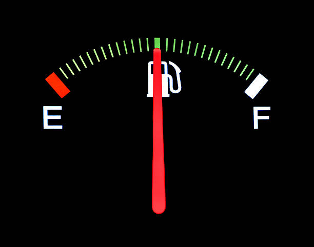 istock Car fuel gauge shows half full on black background 182145772