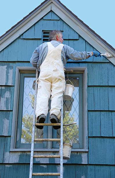istock A man in white overalls painting a house 182145837
