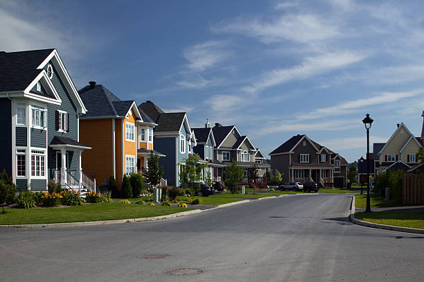 istock Houses align a residential district under a bright blue sky 182145847