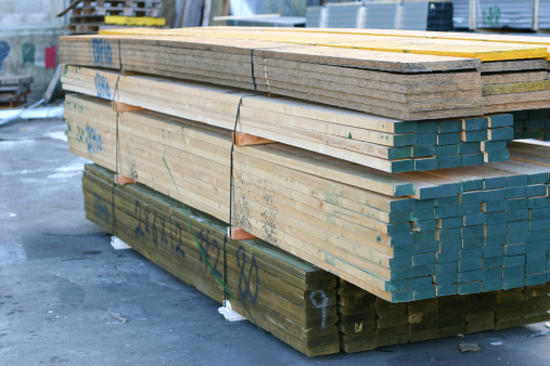 Pressure treated wood pile in lumber yard.