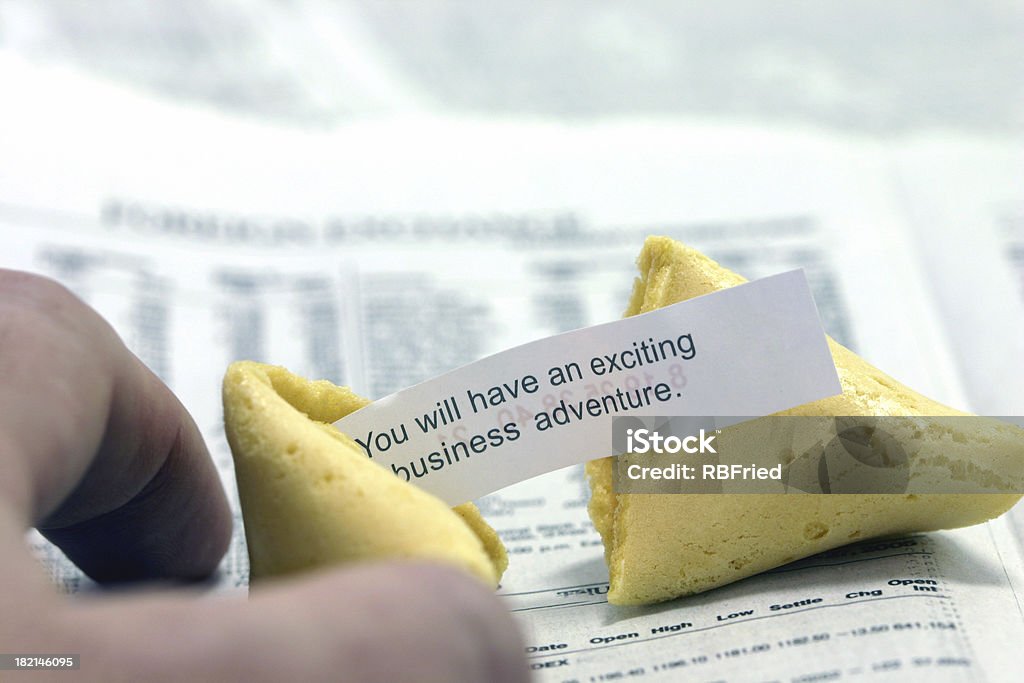 Investing 2 a fortune cookie on a financial newspaper Adult Stock Photo