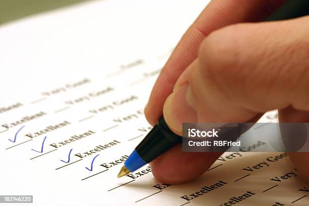 Person Sitting In A Survey Ticking Excellent Stock Photo - Download Image Now - Report Card, Working, Rating