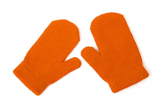 A pair of orange winter mittens isolated on white