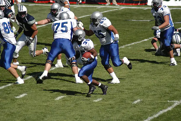 Photo of Young football player rushing for a touchdown