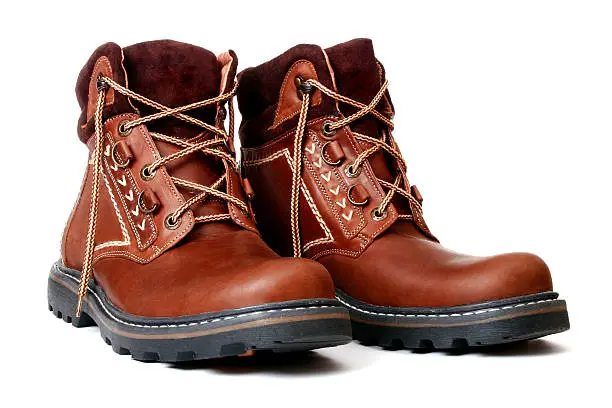 Photo of Pair of new brown leather boots with fabric trim