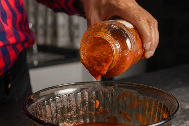 istock Put tomato sauce, cooking delicious food. 1821467044