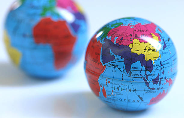 Two small globes showing different views of the Earth stock photo