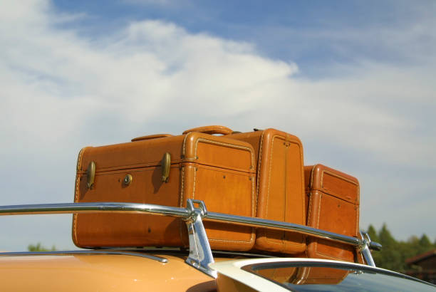 Luggage on roof rack of vintage car stock photo