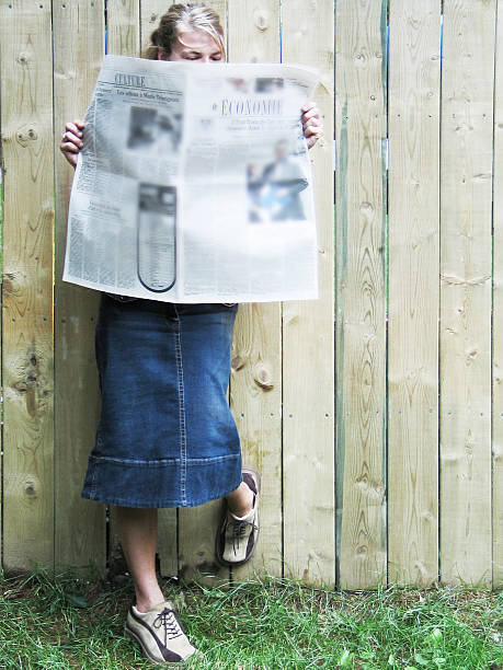 istock young woman reading a newspaper 182147412