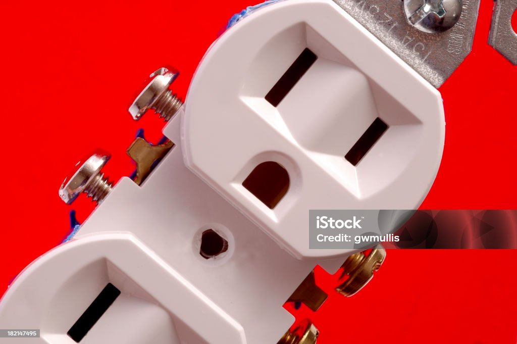 abstract energy A closeup image of an electric receptacle over a red background. Angle Stock Photo