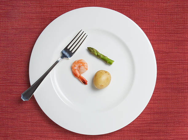 Absurdly Small Diet Meal "tiny meal consisting of one shrimp, a tiny potato, and a single short asparagus stalk" serving size stock pictures, royalty-free photos & images