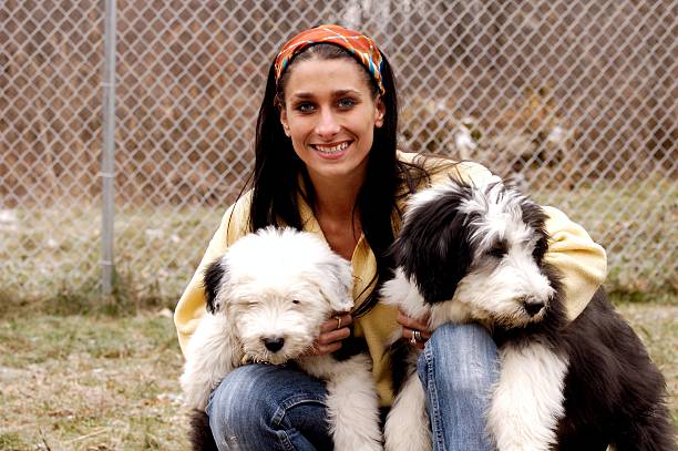 istock A woman hugging her two cute dogs 182148220
