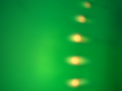5 dots in green light , taken from a lampshade