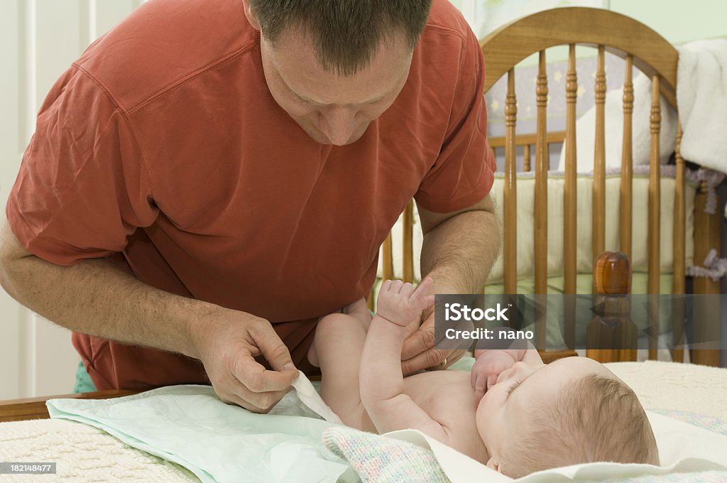 Diapering Dad A dad diapers his chld. Baby - Human Age Stock Photo