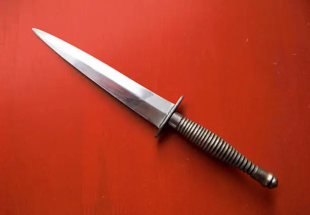 Antique knife on a red background.