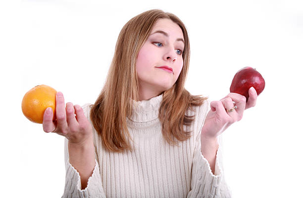 confrontare mele con arance - comparison apple orange isolated foto e immagini stock