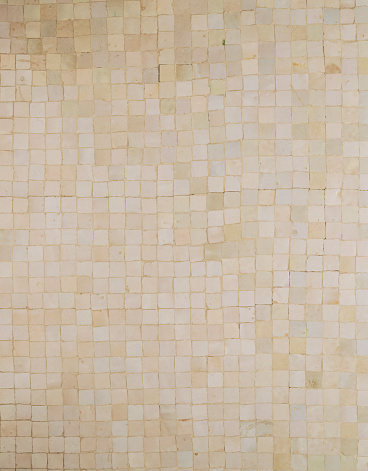 A closeup shot of gold square mosaic tiles for texture and background