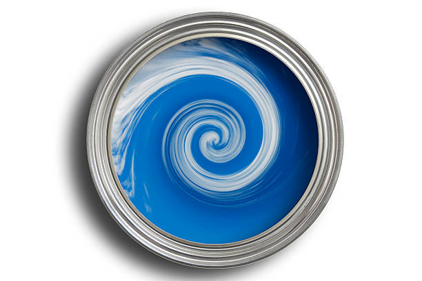Open paint tine with blue paint being mixed in it Mixing Paint mixing stock pictures, royalty-free photos & images