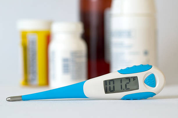 Digital Thermometer and Medication stock photo