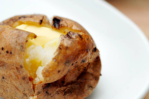 istock Baked jacket potato with butter on plate 182148904