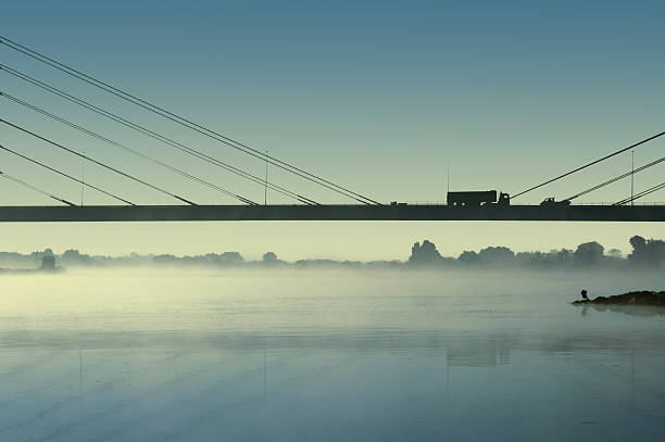 Traffic on a bridge in the mist stock photo