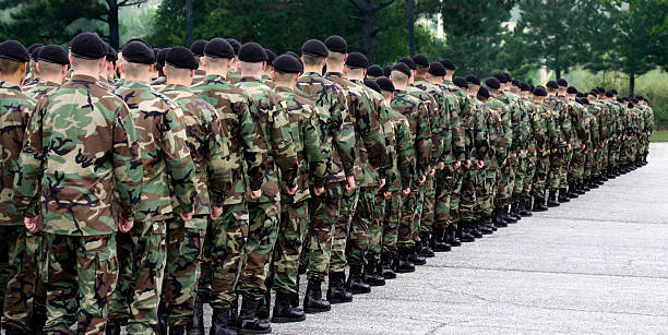 Army soldiers standing in a straight line Soldiers line up on the parade ground ready to begin their service. military parade stock pictures, royalty-free photos & images