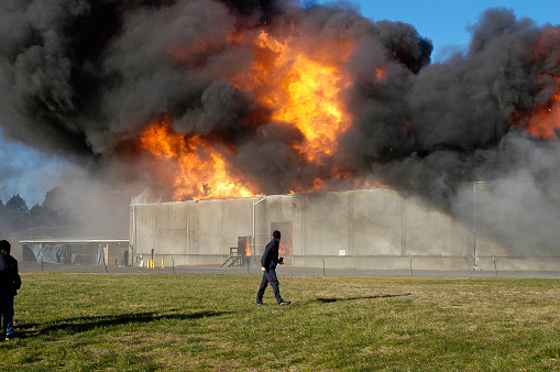 Explosive warehouse fire ignited by fireworks consumes all but the exterior concrete walls