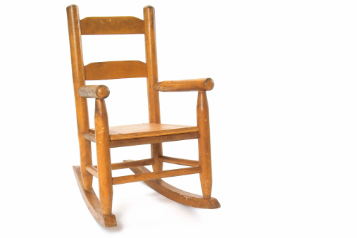 Photo of a well-worn (but not worn out) antique childrens' rocking chair.