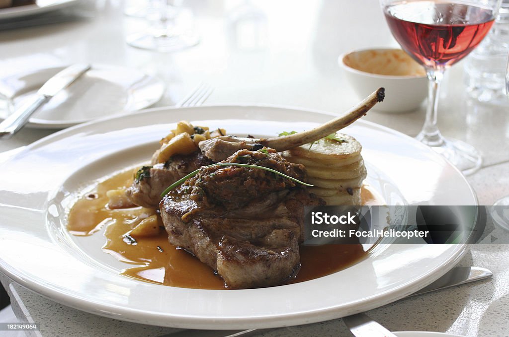 grilled gourmet pork dinner Beautiful plate and dinner setting with pork in restaurant scene. Bright Stock Photo