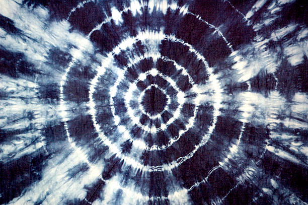 Indigo Tie Dye Fabric Indigo tie dye fabric in groovy circular pattern. Self-made pattern on fabric. peace sign fabric stock pictures, royalty-free photos & images