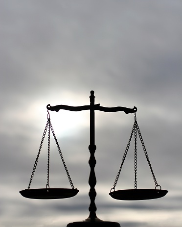 Vertical image of balance scale with plenty of room for text in the sky.
