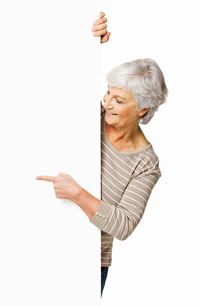Senior Woman Pointing Around a Wall - Isolated