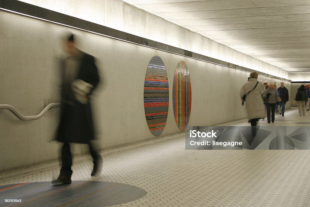 walking in a hall Walking people in a hallway at a subway station. Adult Stock Photo