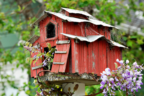 Very cool birdhouse made to look like a dilapidated old barn complete with cobwebs.