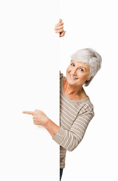 istock Elderly Woman Pointing Around a Corner - Isolated 182151396