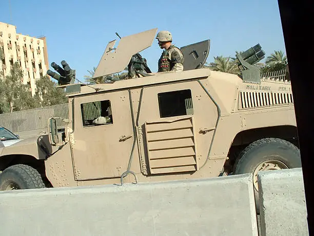 "Taken in the center of Baghdad, the capital of Iraq two months after the town was take by US army. US patrol in the protected area of the city on an armoured car. Canon 300D."
