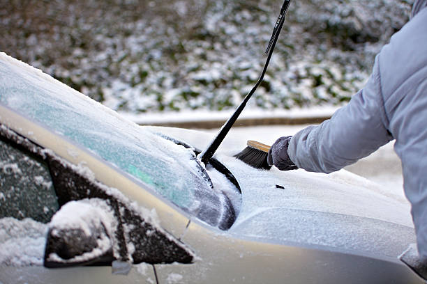 istock Swiping snow from car 182151964