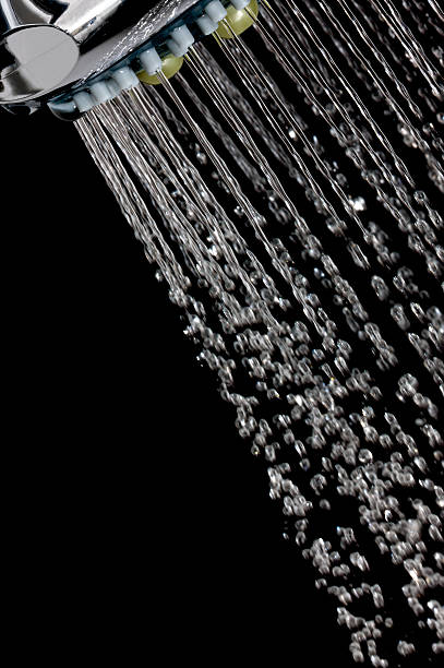istock Jets of water from a shower head on black background 182152140