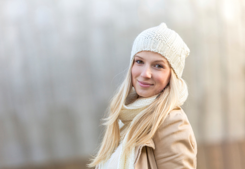 Happy looking young woman in winter clothes